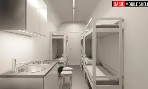 Wnętrze taniego schronu przydomowego z aneksem kuchennym i łóżkami piętrowymi.